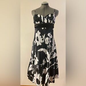 Silky Black and White, floral print dress with satin bow and adjustable straps.